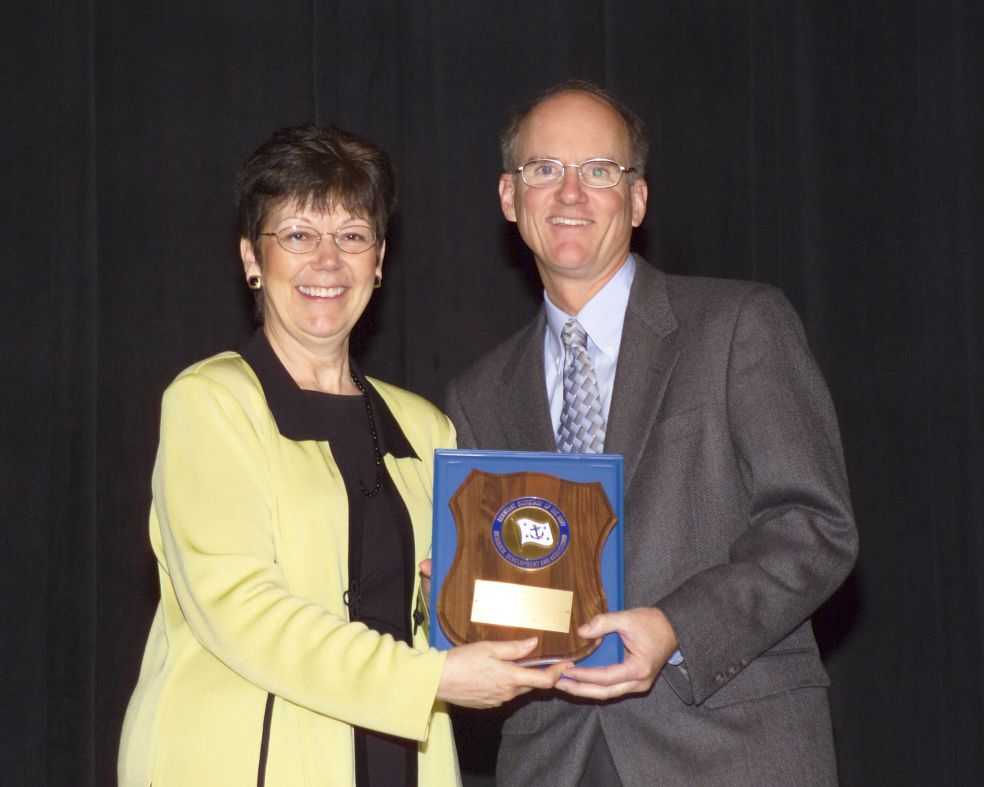 Jeff Waters AHS 1975 receiving top Navy award